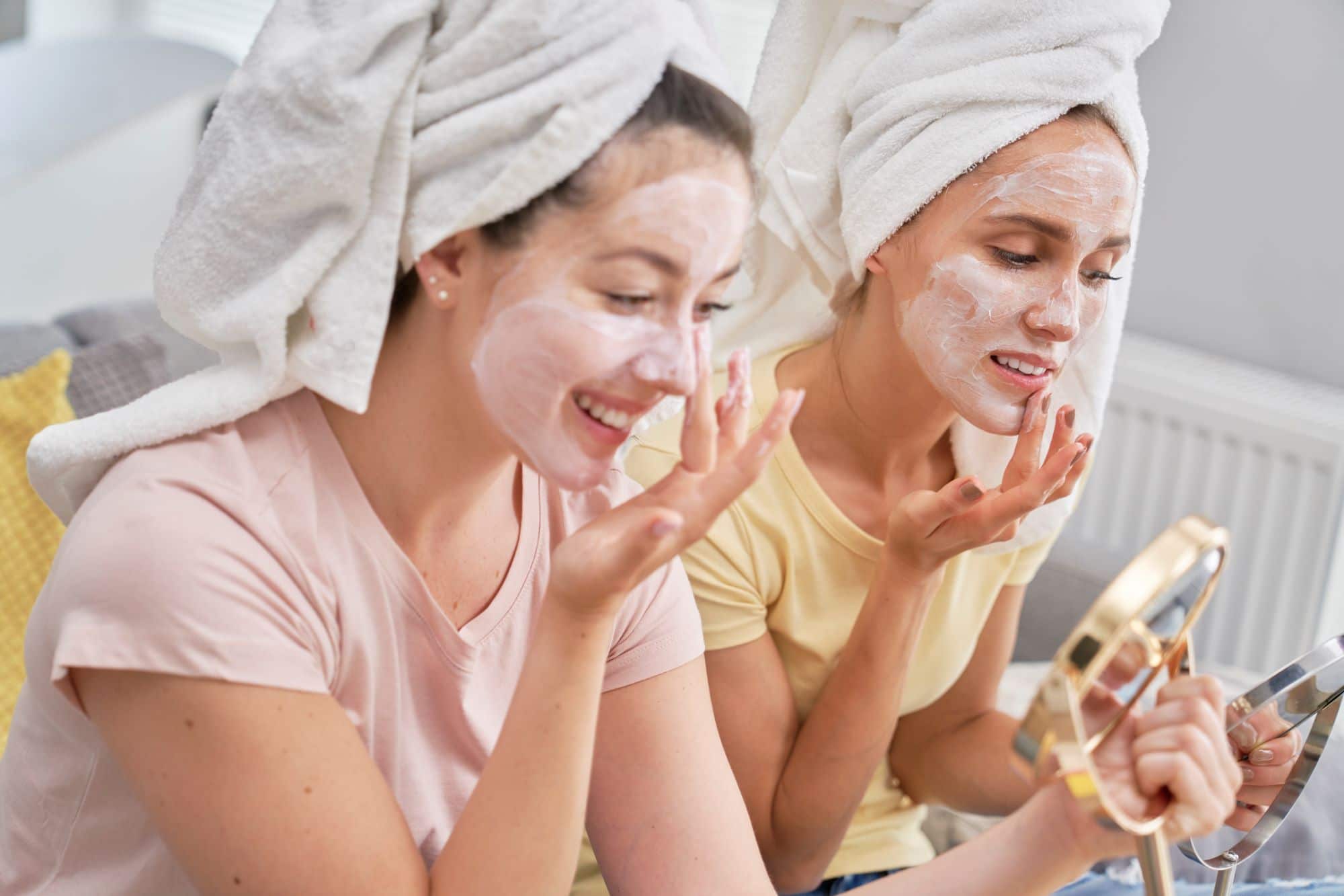 Two young ladies applying Face Mask