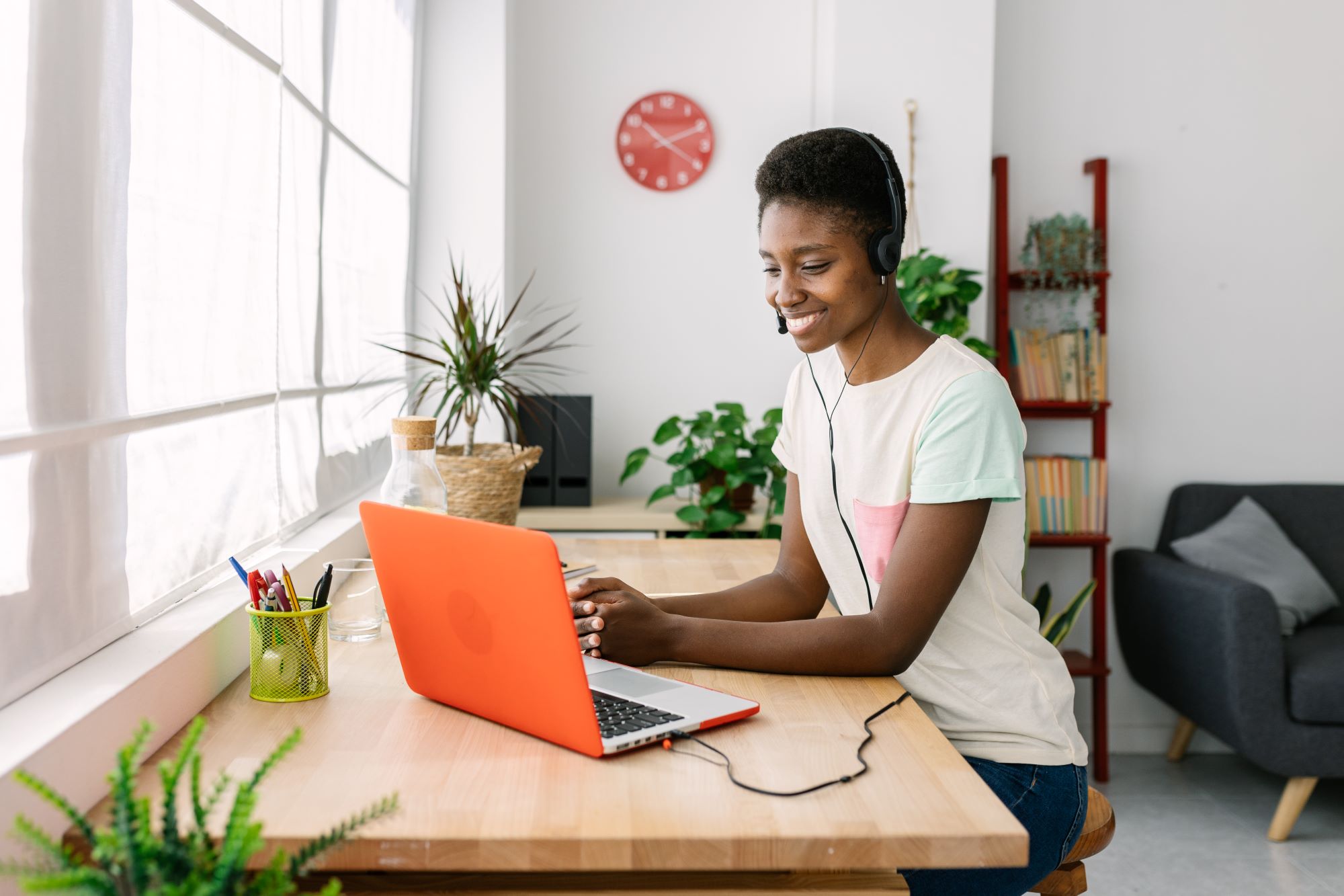 young-african-woman-with-headset-working-from-home-Tips To Avoid Online Distractions And Focus On Work