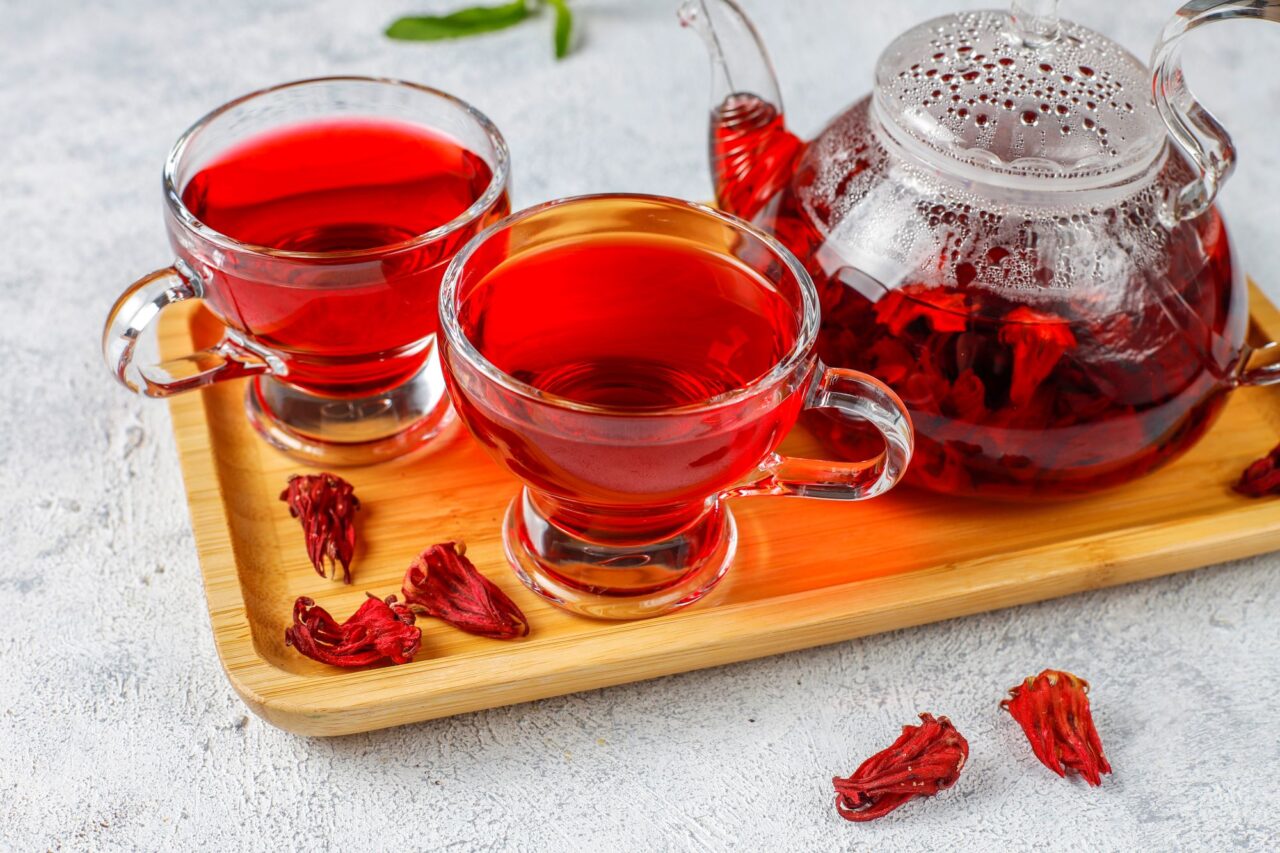 Hot Hibiscus tea in a glass mug and glass teapot