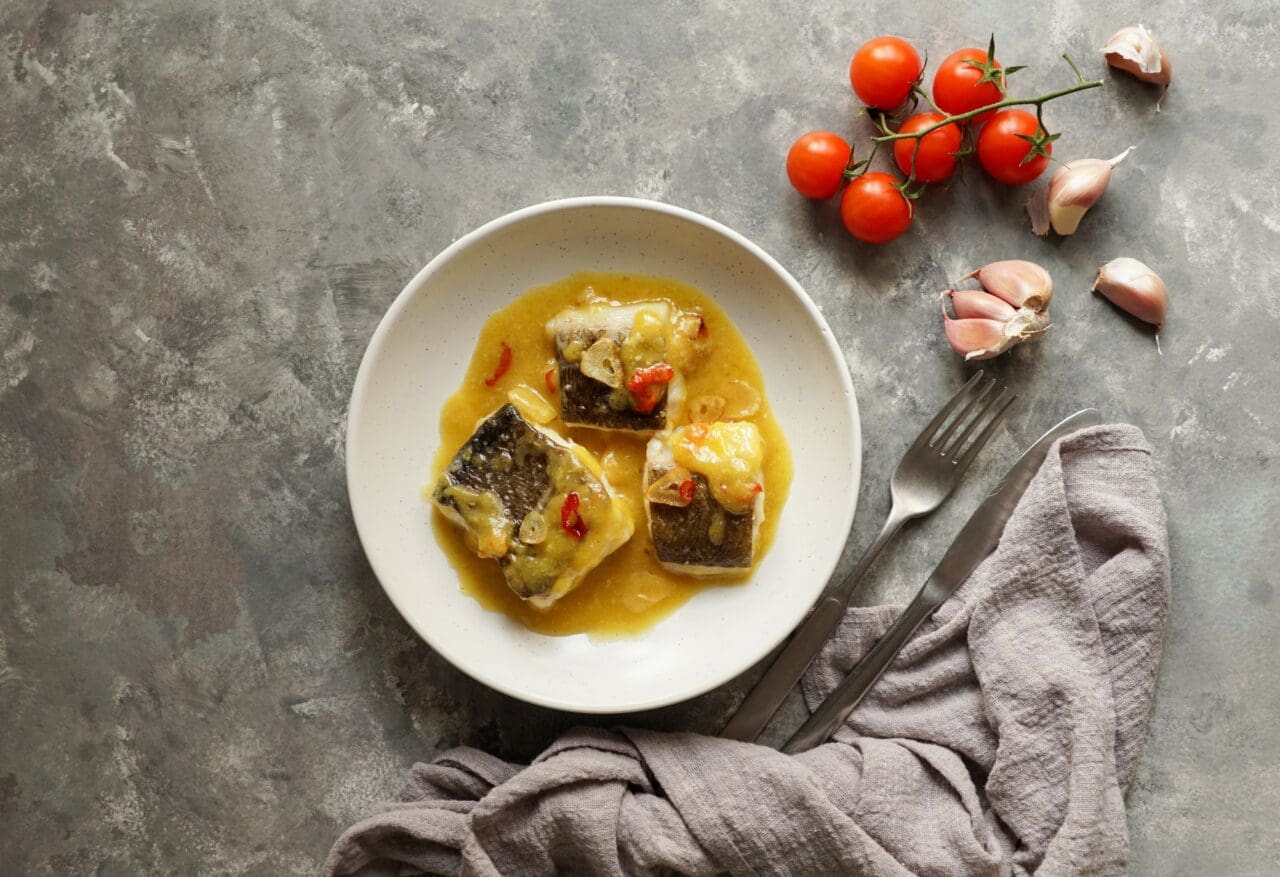 bacalao al pil pil, salted cod in emulsified olive oil sauce, spanish cuisine, basque country
