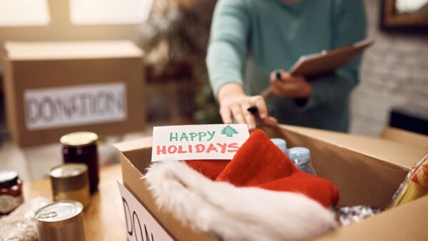 Close-up of woman preparing donation boxes during post holiday decluttering
