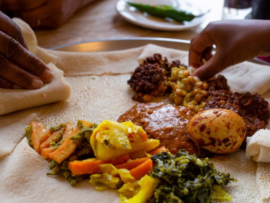 Vegetarian Injera meal with shiro, lentils and egg -