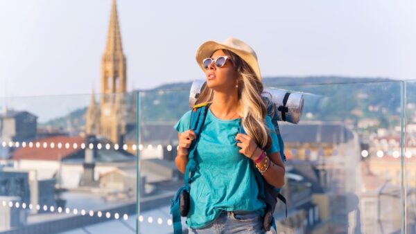 Young travel girl with backpack and sleeping bag, enjoying the freedom of bohemian vacations-Guide to Solo Female Travel