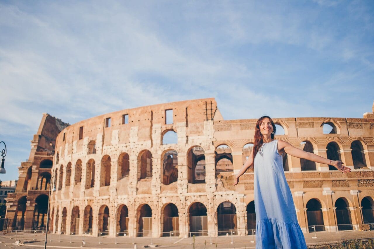 Young woman in front of colosseum in rome, italy