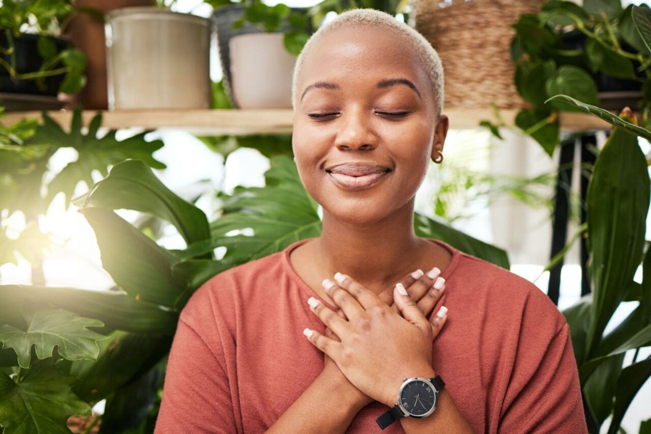 Zen, breathing and calm woman by plants for breathing exercise in meditation in a nursery